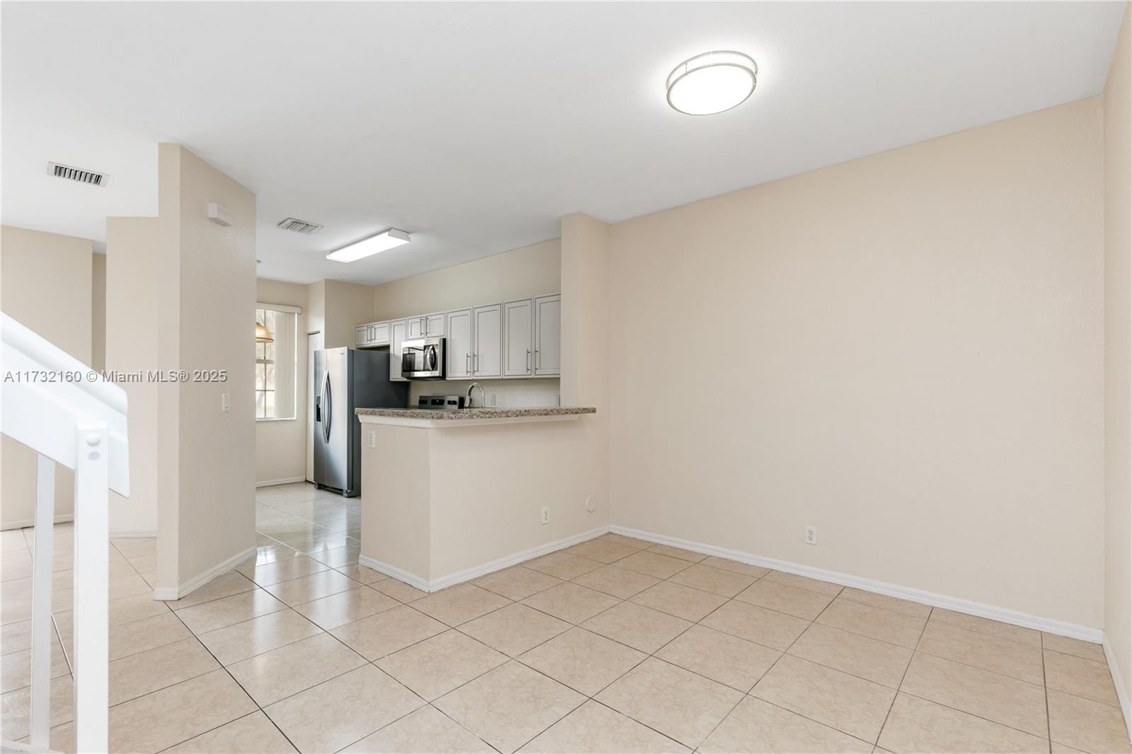 Spring Tree Sunrise, FL 33351 - Photo 12 of 44 a view of a kitchen with a sink and dishwasher a refrigerator with white cabinets