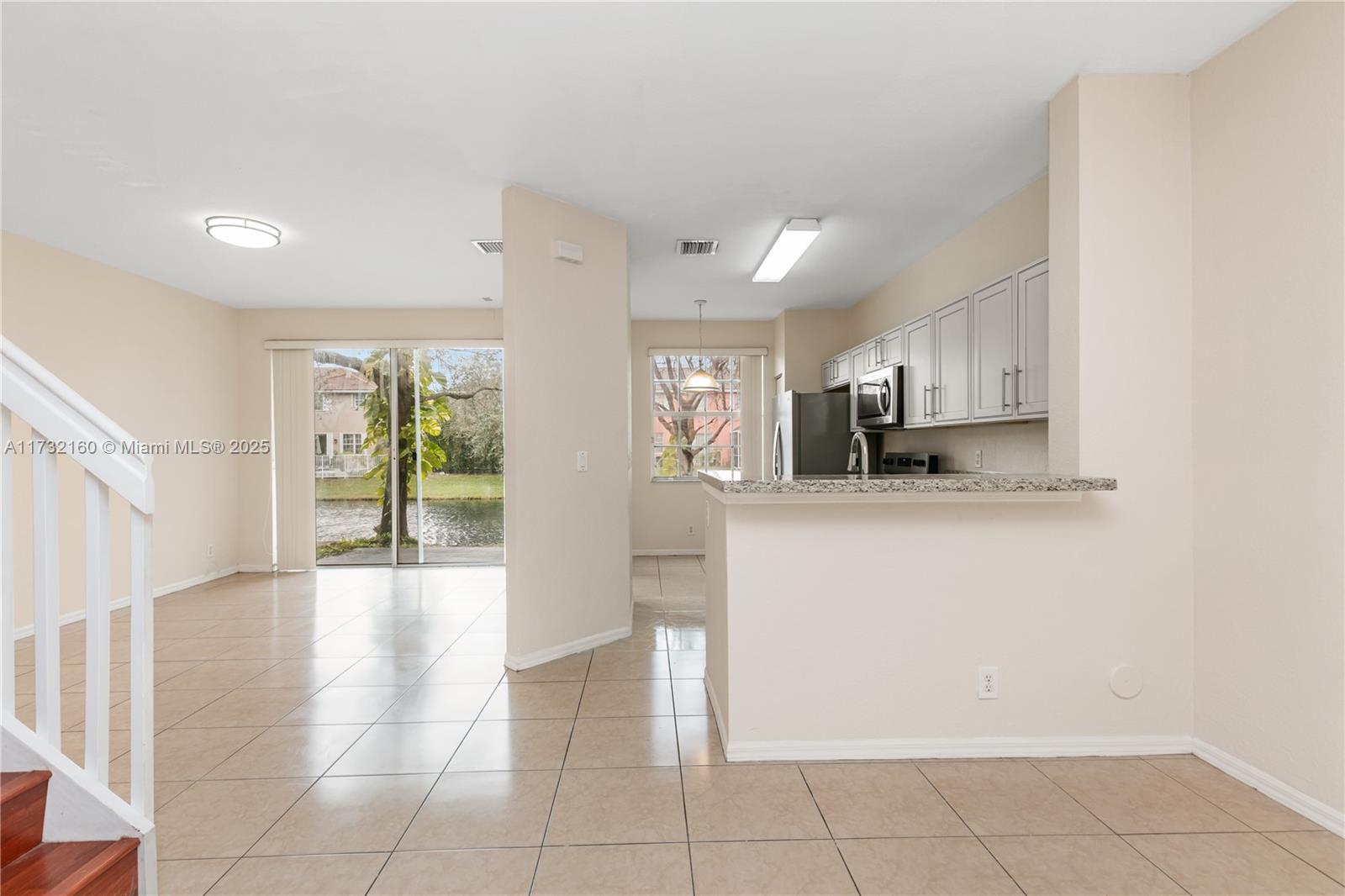 Spring Tree Sunrise, FL 33351 - Photo 13 of 44 a view of a kitchen with an empty space and a window