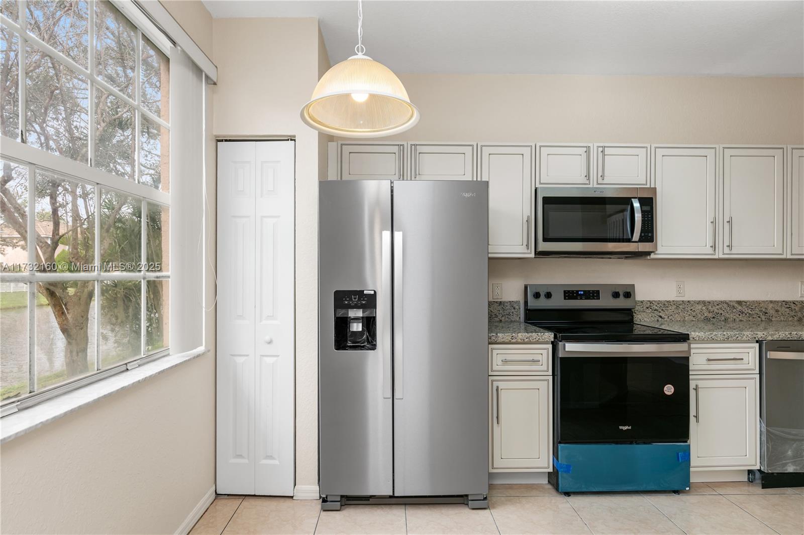 Spring Tree Sunrise, FL 33351 - Photo 2 of 44 a kitchen with stainless steel appliances a stove a microwave and a refrigerator