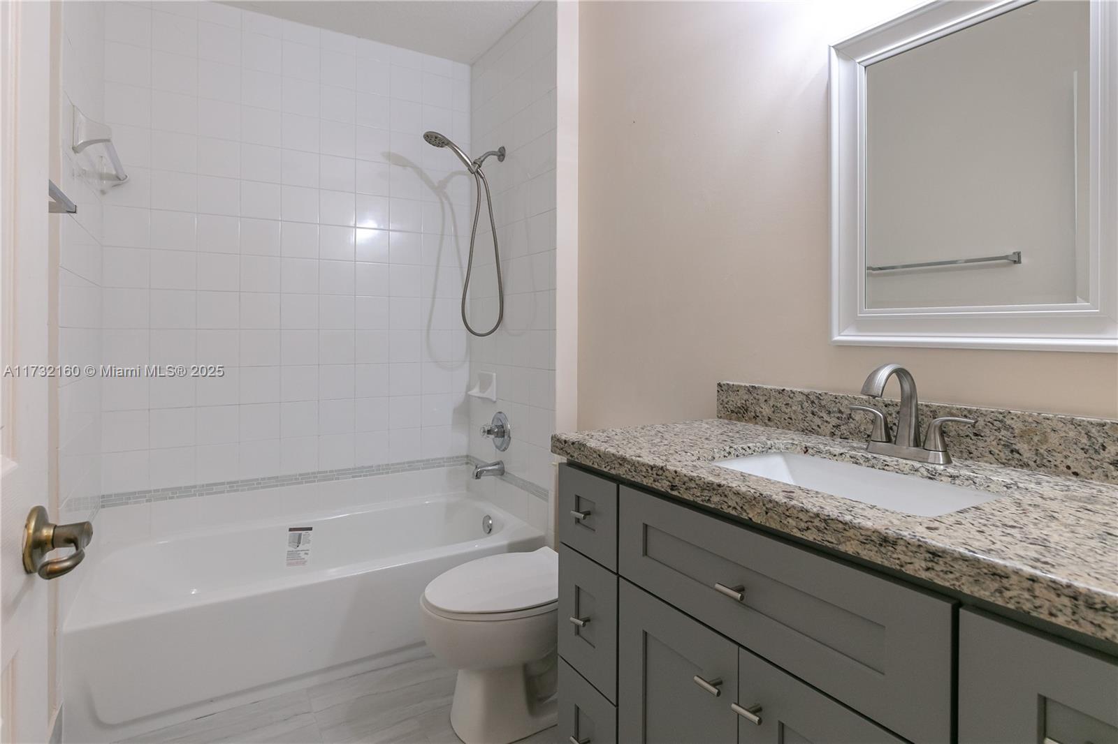 Spring Tree Sunrise, FL 33351 - Photo 22 of 44 a bathroom with a granite countertop bathtub shower sink vanity and toilet
