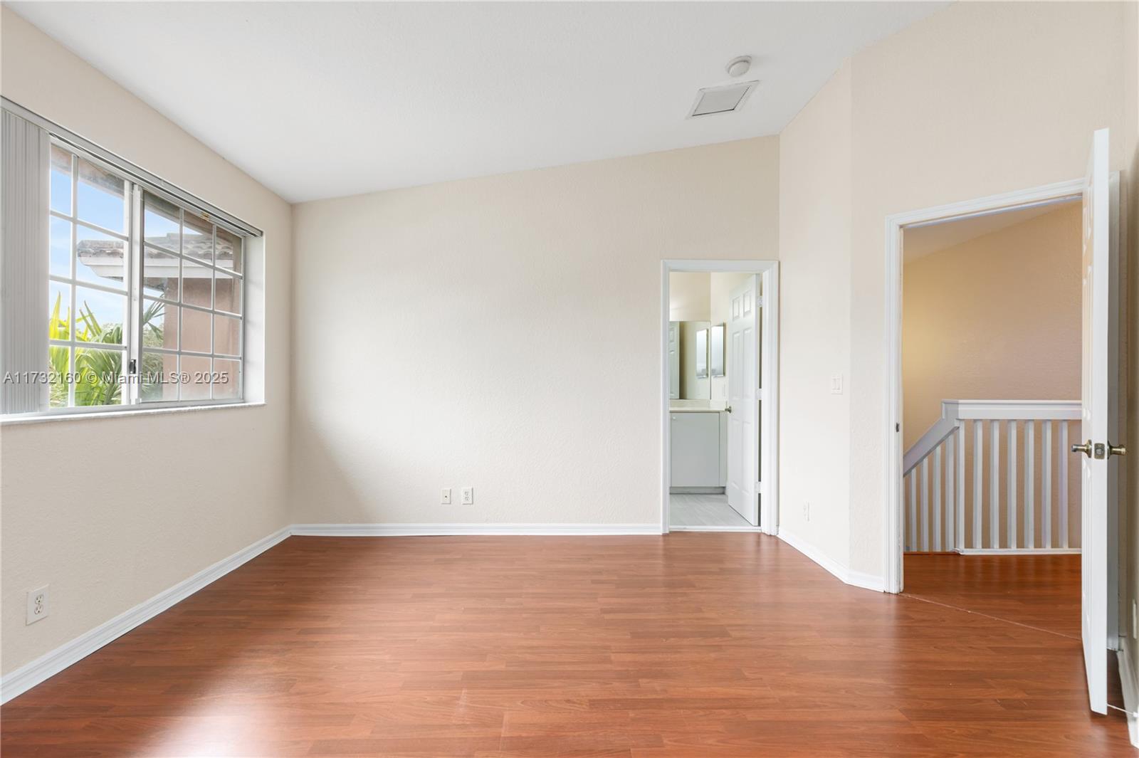 Spring Tree Sunrise, FL 33351 - Photo 25 of 44 a view of an empty room with wooden floor and a window