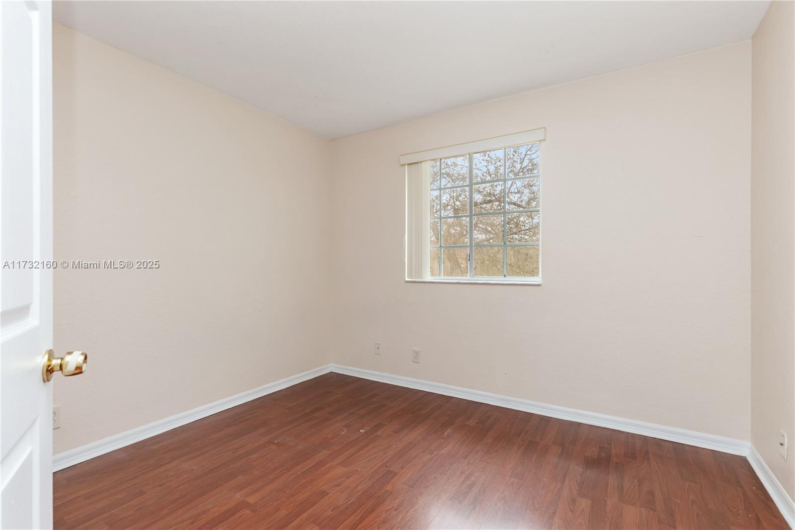 Spring Tree Sunrise, FL 33351 - Photo 28 of 44 an empty room with wooden floor and window