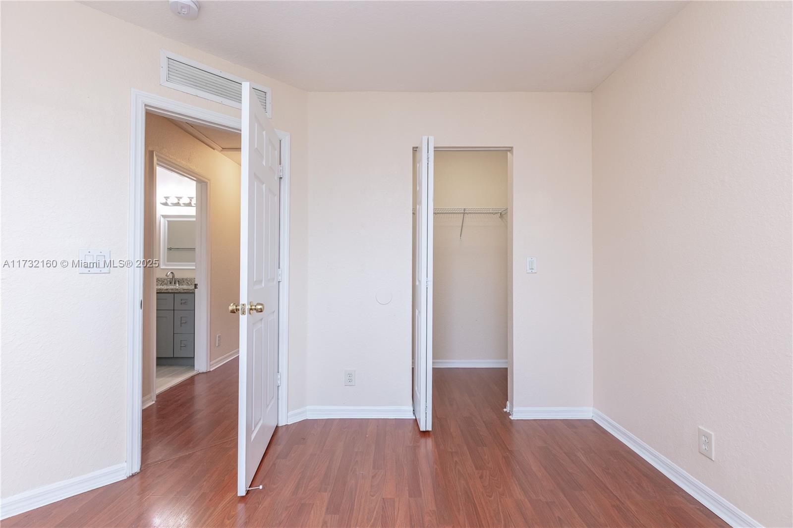 Spring Tree Sunrise, FL 33351 - Photo 29 of 44 an empty room with wooden floor and a window