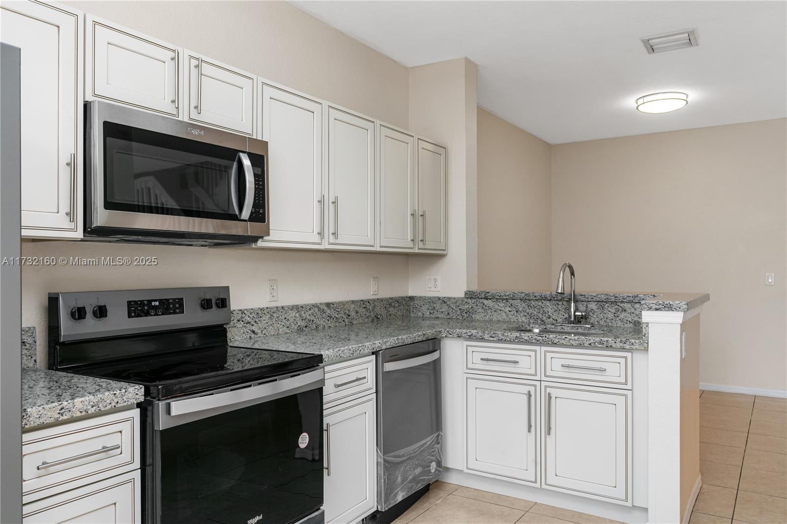 Spring Tree Sunrise, FL 33351 - Photo 3 of 44 a kitchen with appliances cabinets and a stove top oven