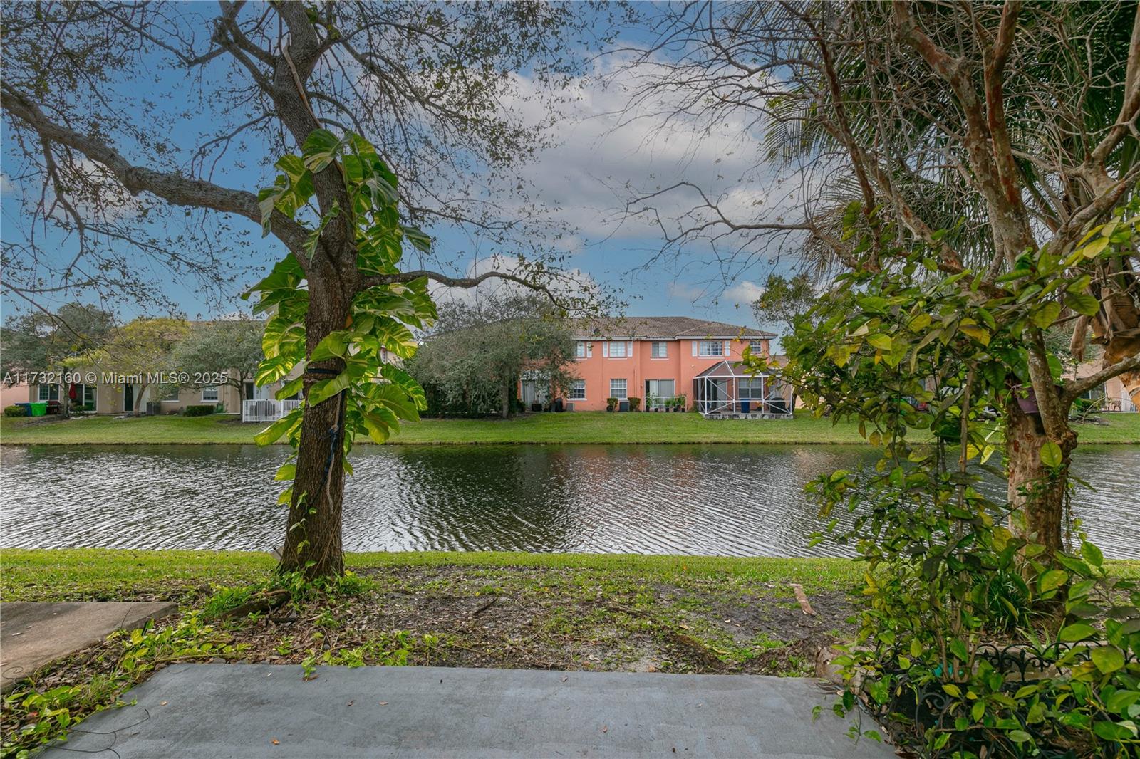 Spring Tree Sunrise, FL 33351 - Photo 33 of 44 an aerial view of a house with a yard and a large tree