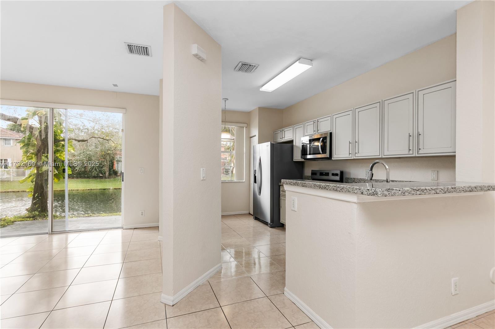 Spring Tree Sunrise, FL 33351 - Photo 4 of 44 a kitchen with stainless steel appliances granite countertop a refrigerator and a sink