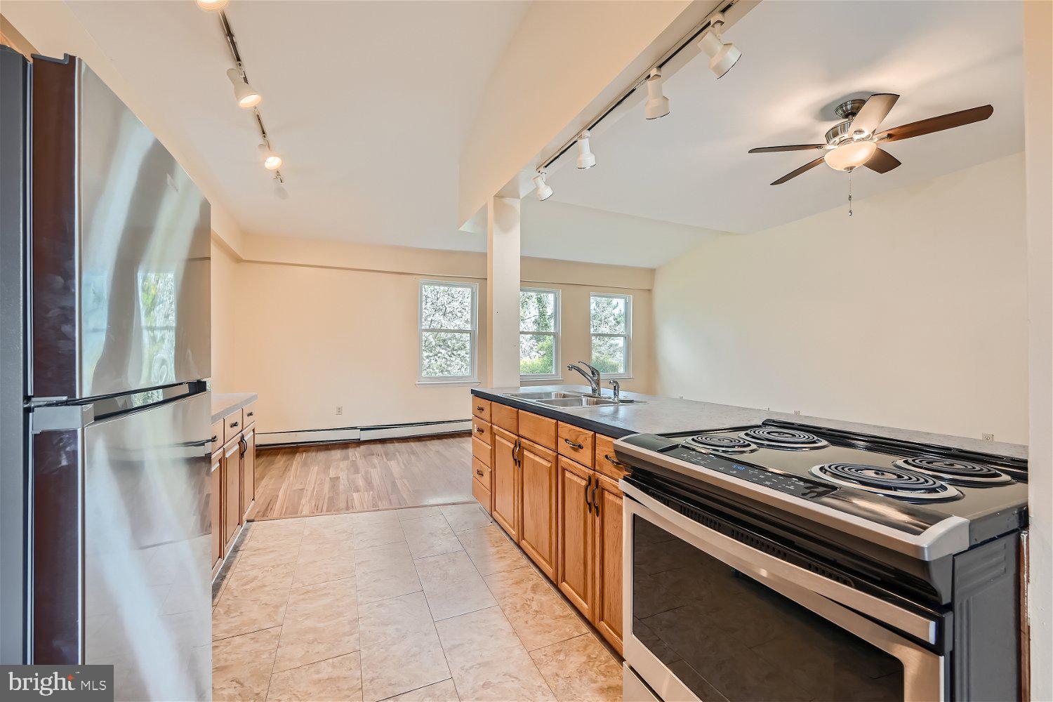 716 South Camp Meade Road, Unit A Linthicum Heights, MD 21090 - Photo 5 of 11 a kitchen with stainless steel appliances a stove a sink and a refrigerator