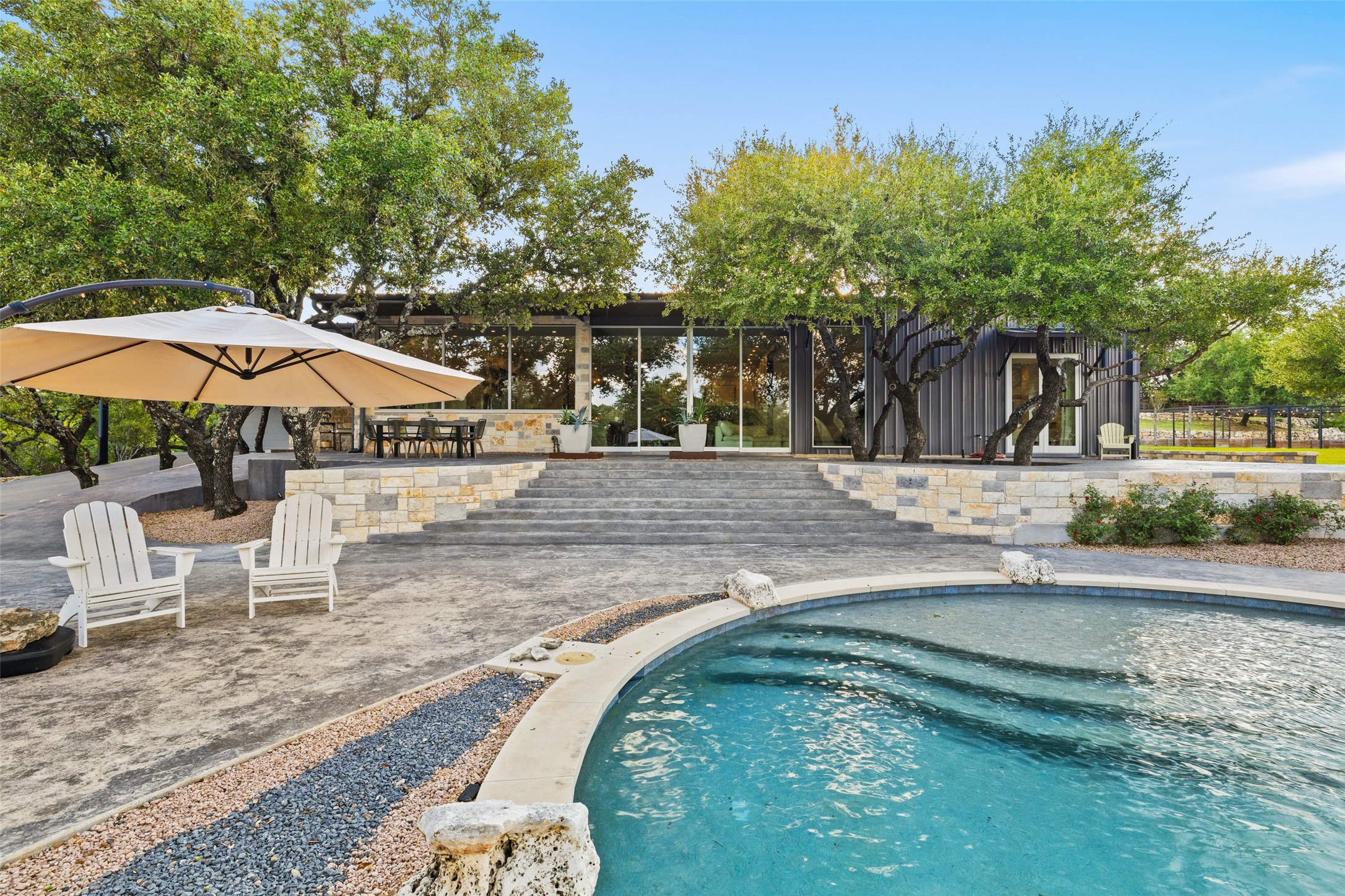 a backyard of a house with barbeque oven table and chairs