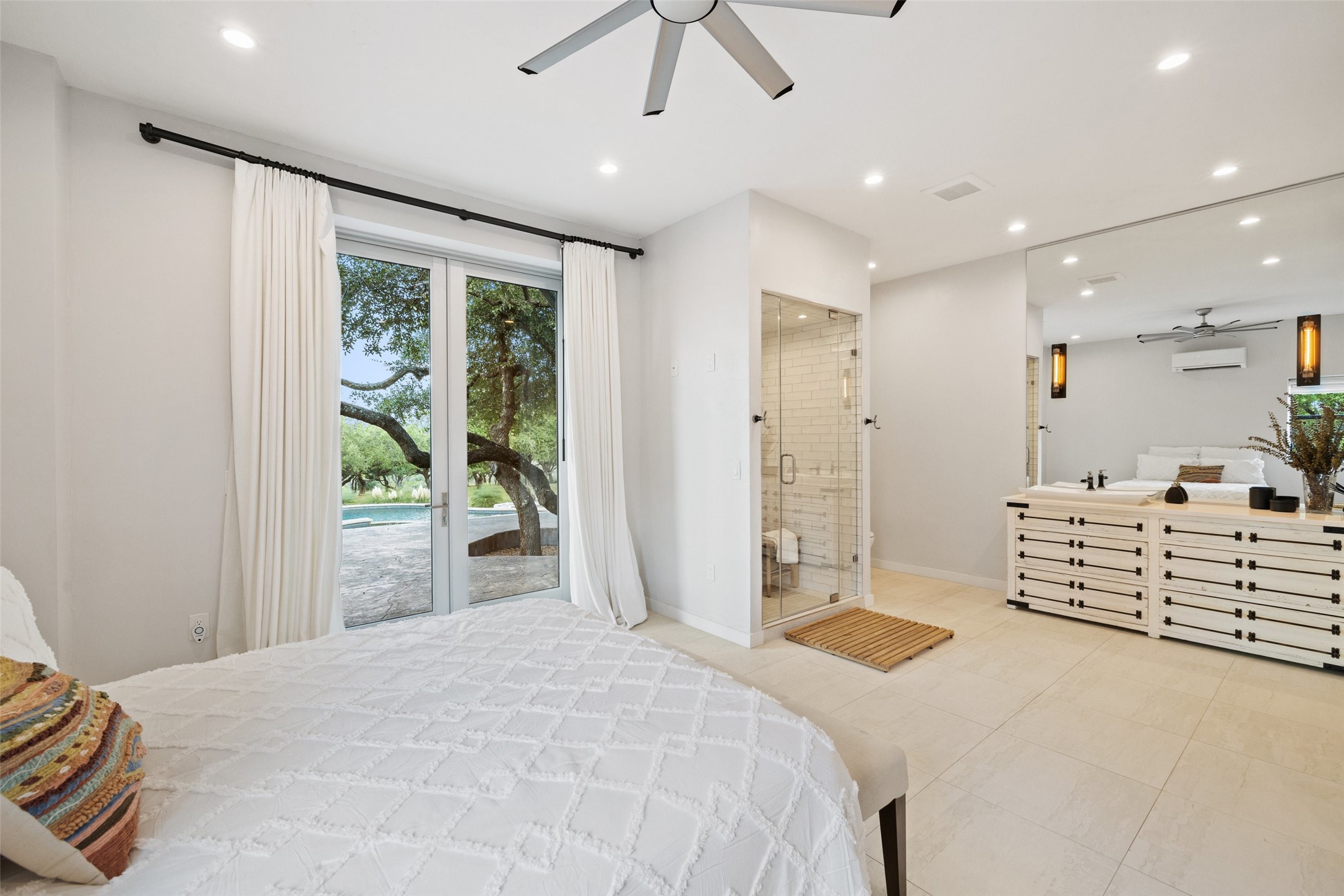 2412 Bee Creek Road Spicewood, TX 78669 - Photo 19 of 40 a bedroom with furniture and a large window