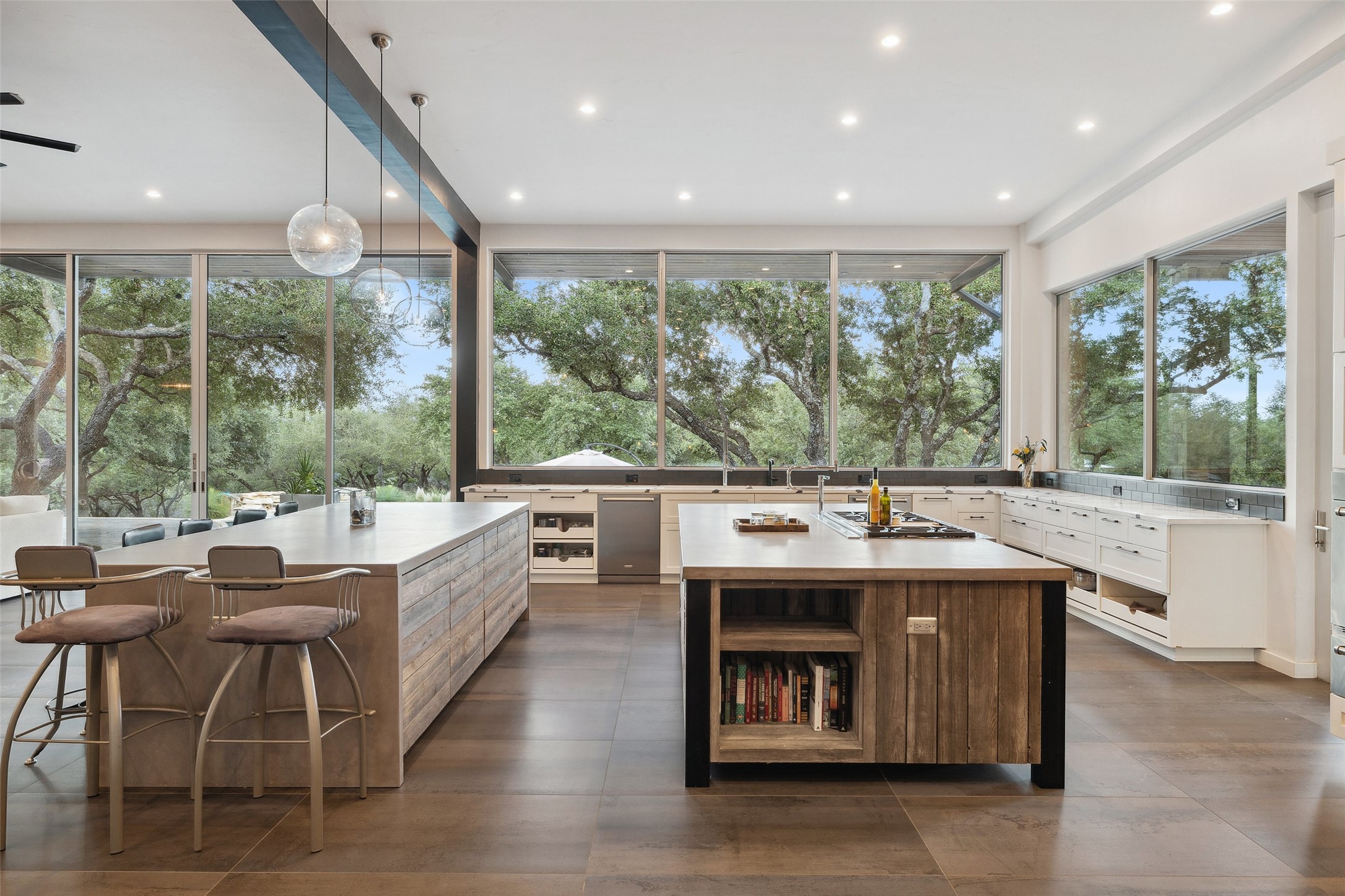 2412 Bee Creek Road Spicewood, TX 78669 - Photo 5 of 40 a large kitchen with kitchen island a large window in it