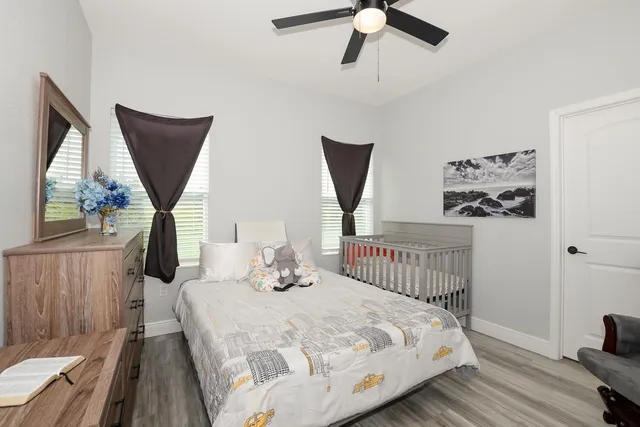 a bedroom with a bed and wooden floor