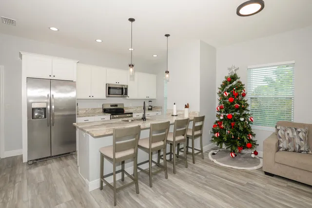 a view of a dining room with furniture wooden floor and a chandelier