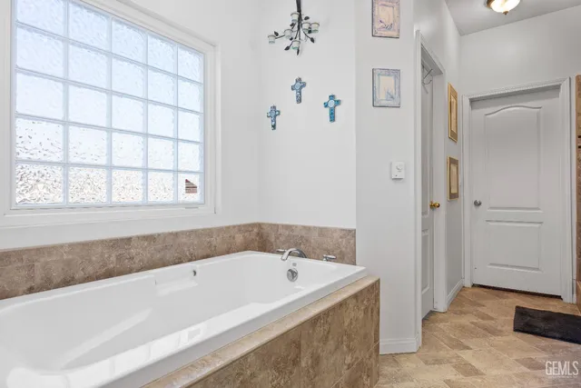 a view of a kitchen with stainless steel appliances granite countertop a stove kitchen island a refrigerator and a stove