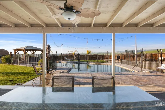 a view of a house with a yard and table