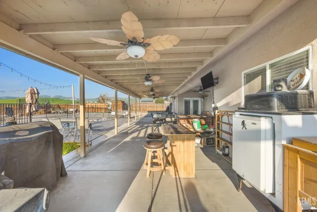 a view of a swimming pool with a bench and trees in the background