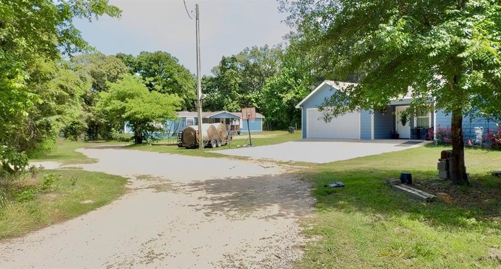 8261 County Road 381 Tyler, TX 75708 - Photo 1 of 40 a view of a yard with plants and a fountain