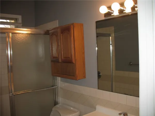 a bathroom with a shower and a sink