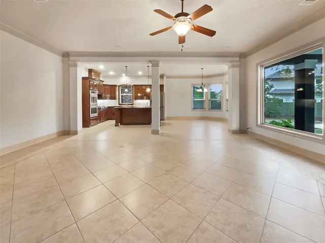a view of a livingroom with furniture and chandelier fan