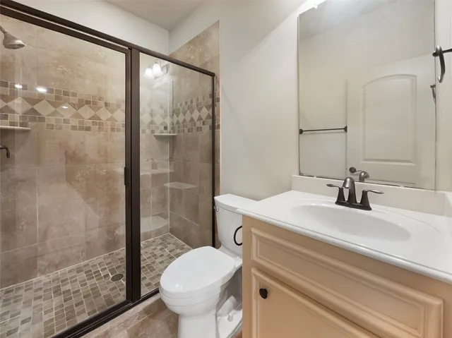 an empty room with windows and ceiling fan