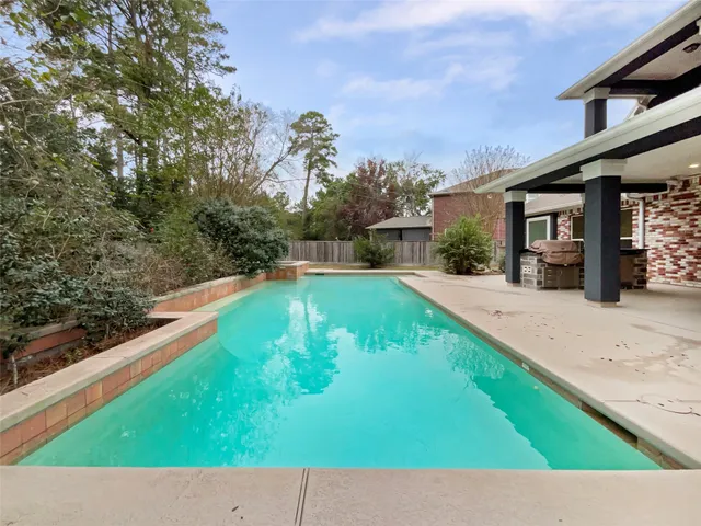 a view of a backyard with swimming pool