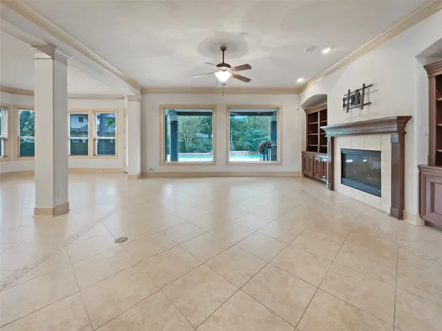 a view of an empty room with a fireplace and a window