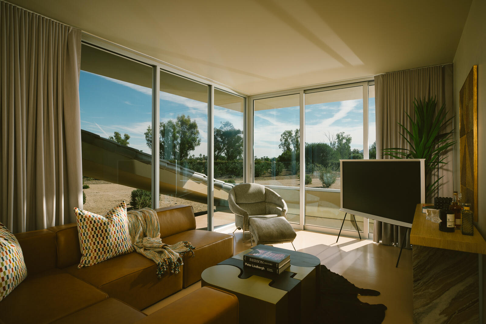 38850 Kelly Lane Rancho Mirage, CA 92270 - Photo 20 of 34 a living room with couch a flat screen tv and floor to ceiling window