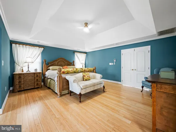 a spacious bedroom with a bed and a window