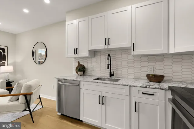 a kitchen with cabinets stainless steel appliances and a sink