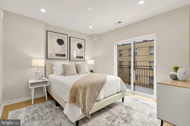 a bed room with a bed and a chair