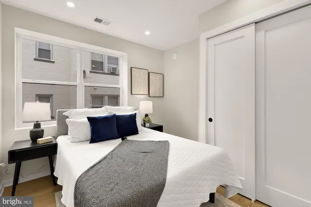 a bedroom with a bed and lamp