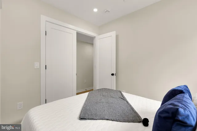 a bedroom with a bed and a closet