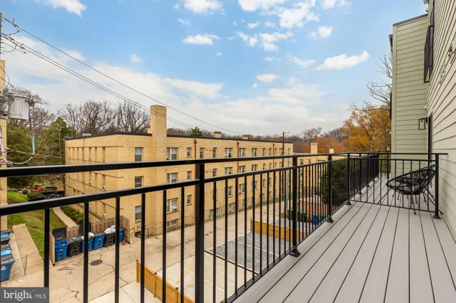 a view of balcony with wooden floor and fence