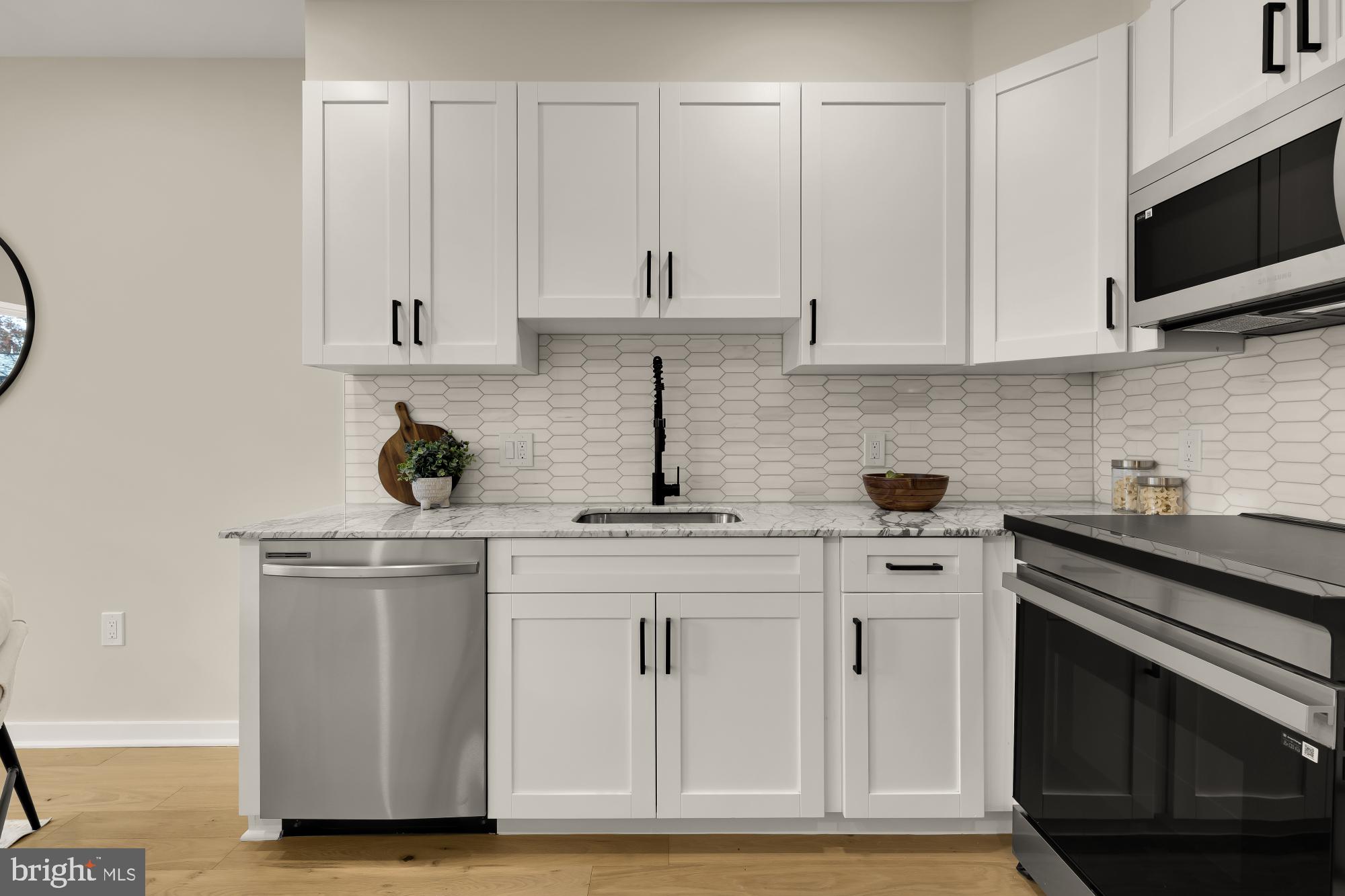 2606 41st Street Northwest, Unit 6 Washington, DC 20007 - Photo 10 of 25 a kitchen with white cabinets and sink