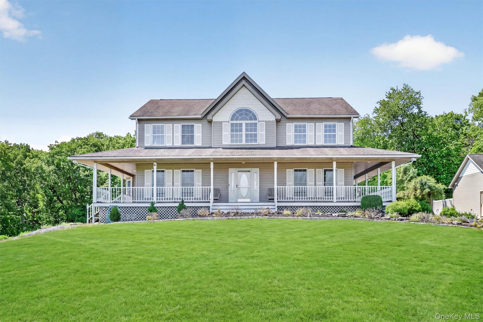 954 Ridgebury Road New Hampton, NY 10958 - Photo 42 of 45 A picture-perfect front view highlights the charm of the home, from the broad porch to the gently rolling lawn that frames it.