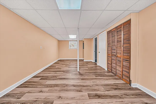 a view of a livingroom with wooden floor and white walls