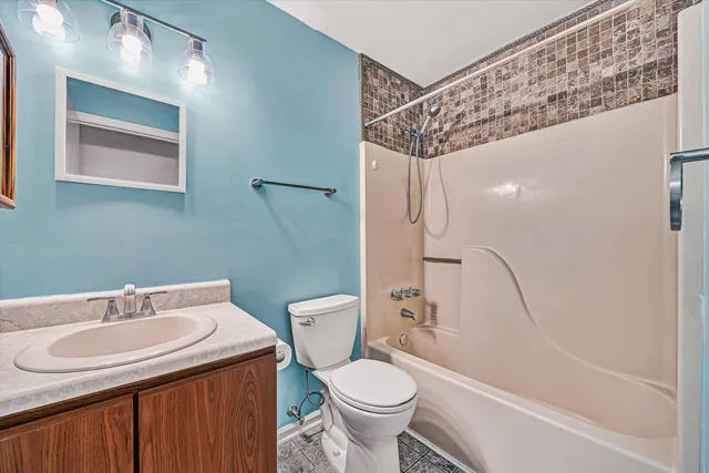a bathroom with a sink toilet and shower