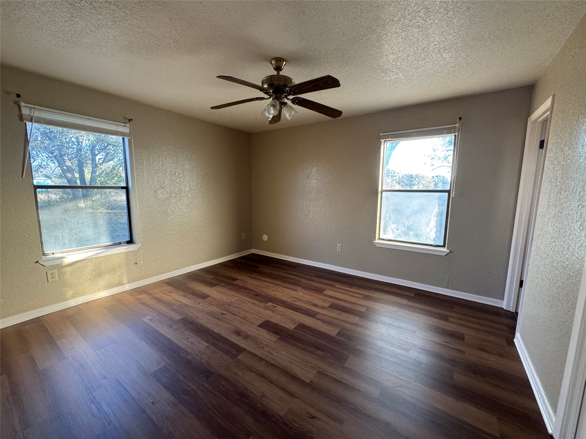 163 Robinson Road Lockhart, TX 78644 - Photo 9 of 21 a view of an empty room with wooden floor and a window