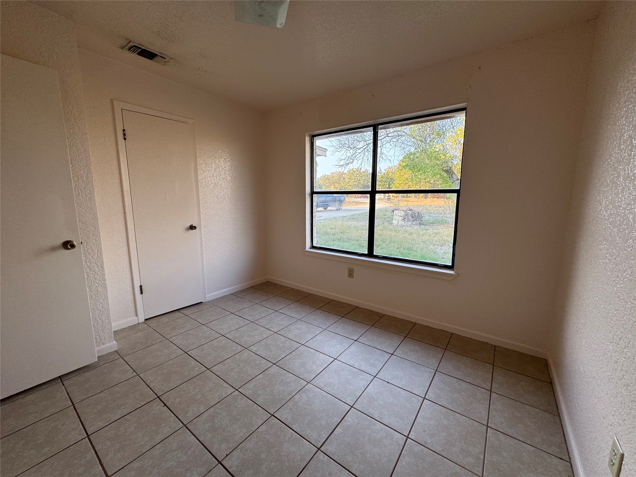 163 Robinson Road Lockhart, TX 78644 - Photo 10 of 21 a view of an empty room with a window