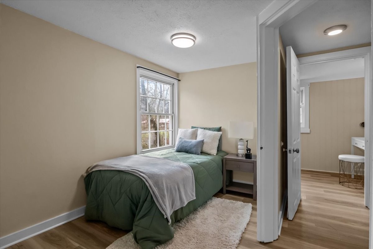 370 Main Street White Bluff, TN 37187 - Photo 18 of 29 a bedroom with a bed and wooden floor