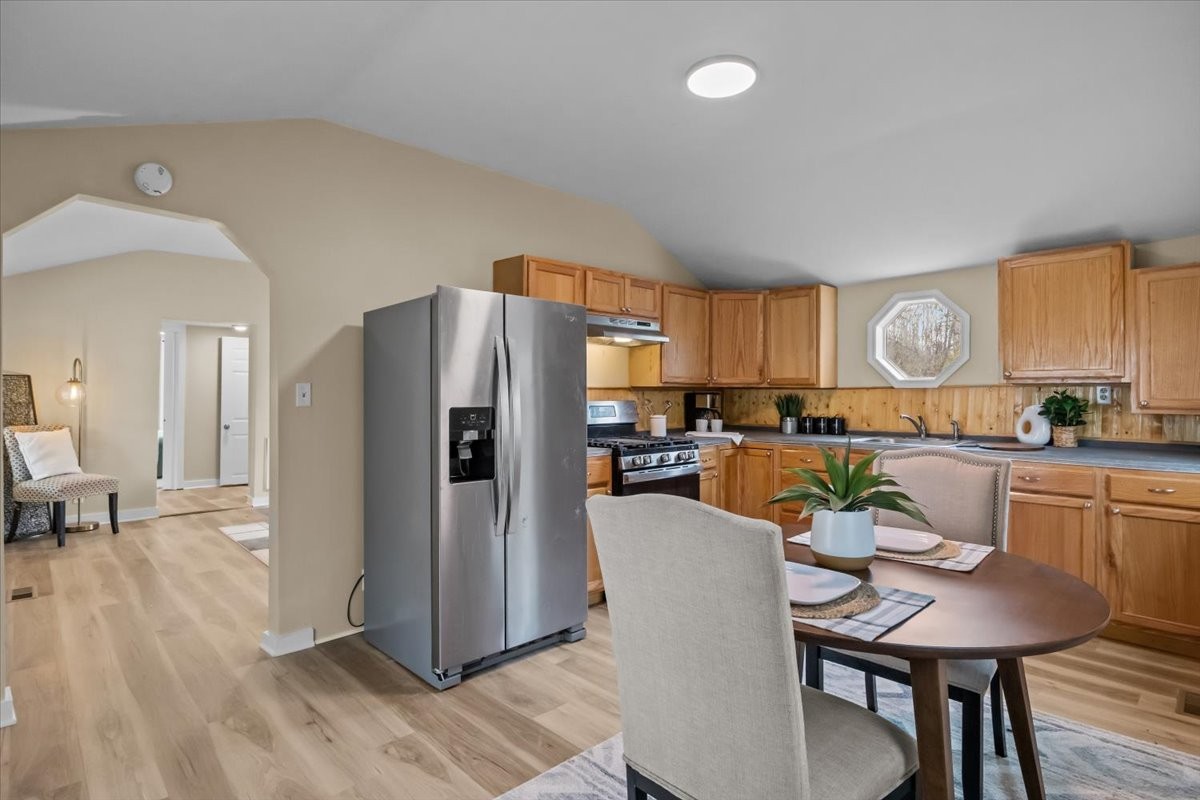 370 Main Street White Bluff, TN 37187 - Photo 6 of 29 a kitchen with stainless steel appliances a refrigerator a stove a dining table and chairs