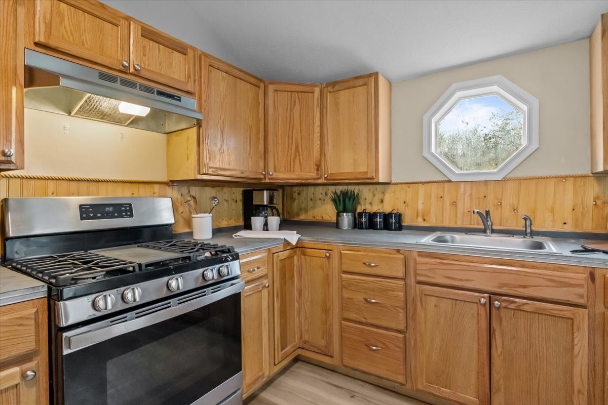 370 Main Street White Bluff, TN 37187 - Photo 8 of 29 a kitchen with stainless steel appliances granite countertop a stove a sink and a microwave