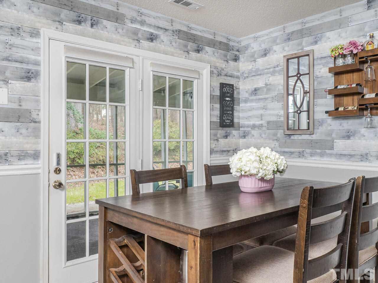730 Red Forest Trail Raleigh, NC 27615 - Photo 14 of 27 a view of a dining room with furniture and wooden floor