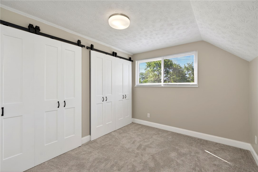 5975 Rosalie Road Dayton, OH 45424 - Photo 23 of 48 This cozy bedroom features elegant sliding barn doors and plush carpeting.
