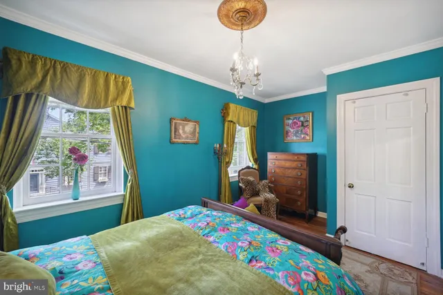 a bedroom with a bed and a dresser in it