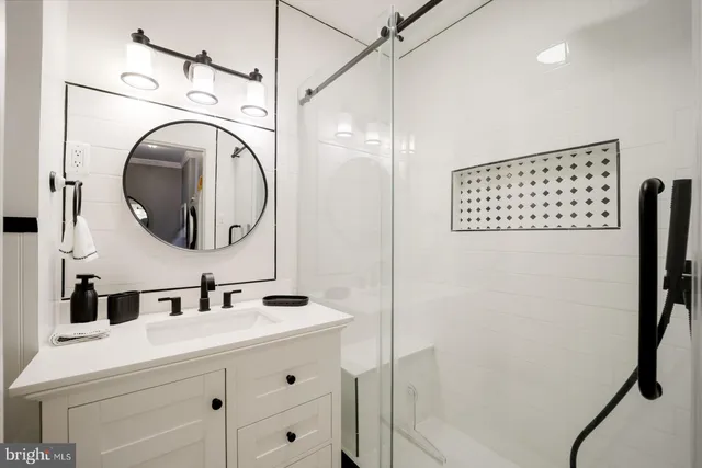 a bathroom with a sink vanity and a mirror