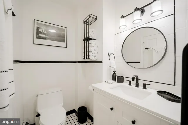 a bathroom with a sink mirror and vanity