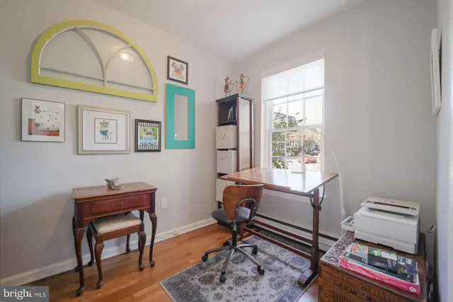 a view of a workspace with furniture and a window