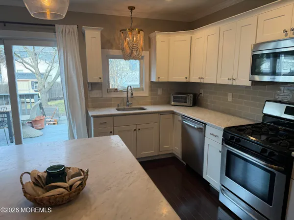 a kitchen with stainless steel appliances a stove a sink and a microwave