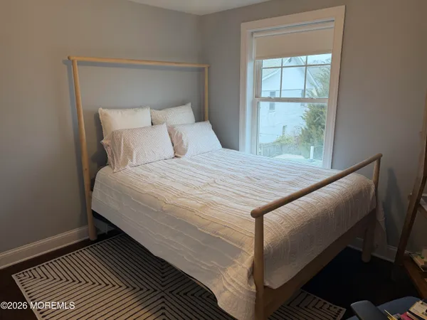 a bed sitting in a bedroom next to a window