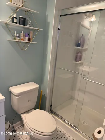 a white toilet and shower in a bathroom